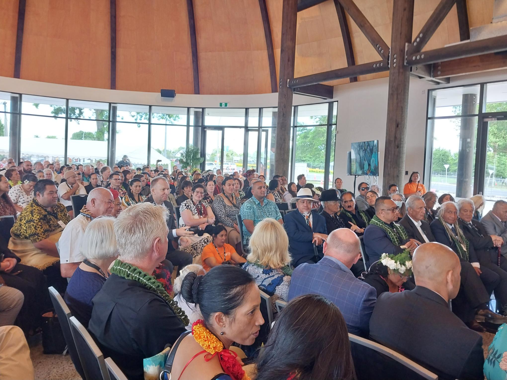 Inside the fale, full of seated guests at the opening.