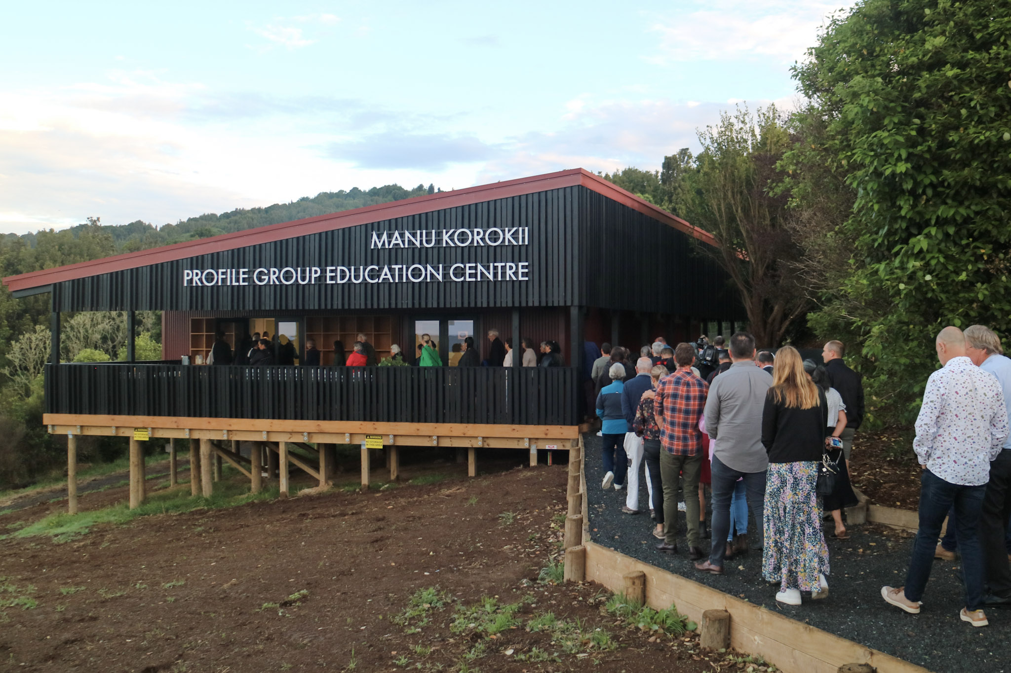 Group of people walking to enter the Manu Korokii Profile Group Education Centre for the first time.