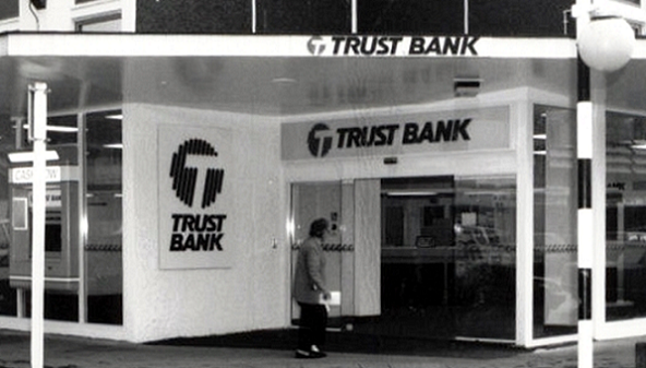 An old black and white photo of a Trust Bank branch