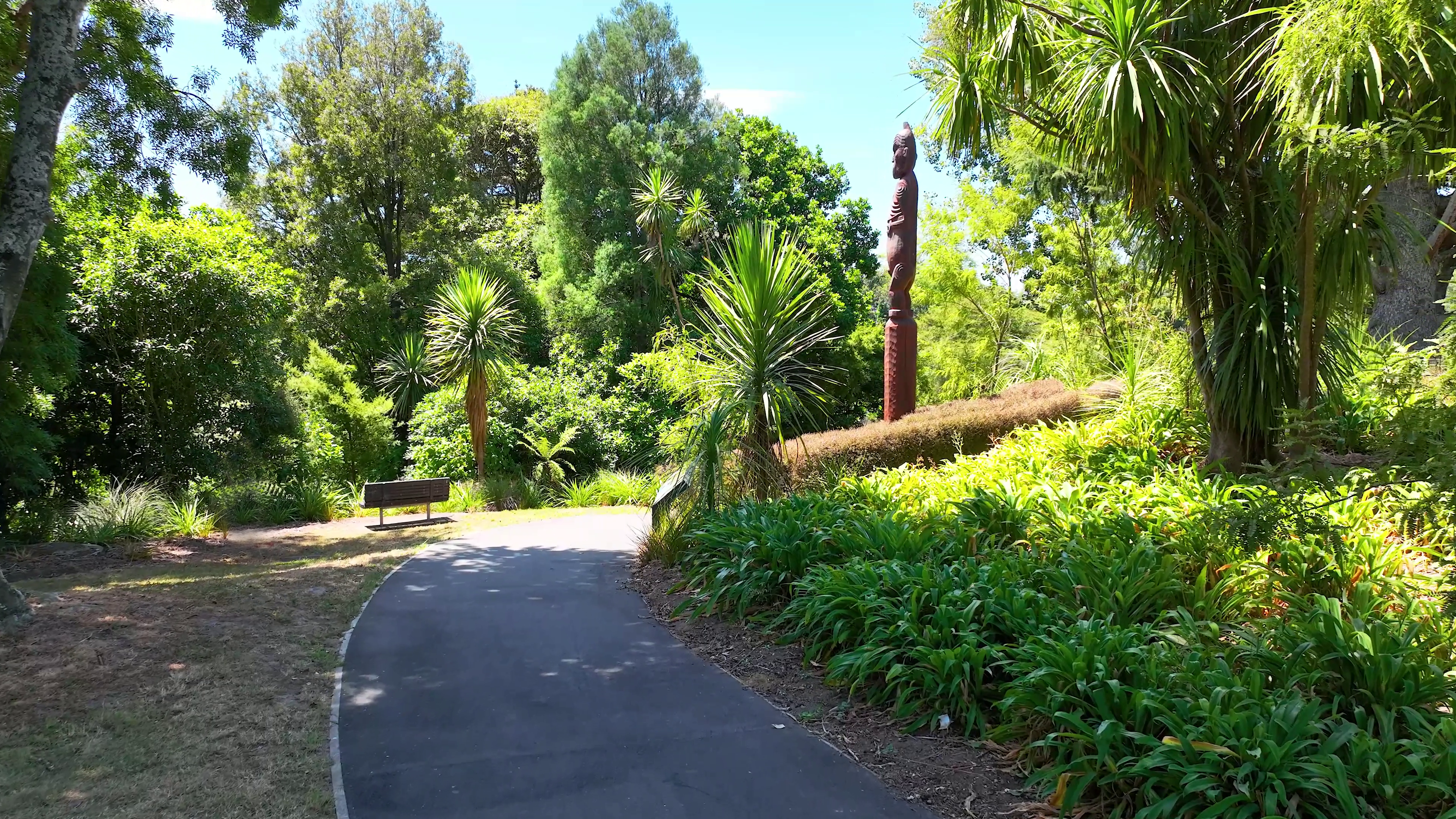 Pathway along Kirikirioa Paa and the Waikato River adjacent to the Trust Waikato office featuring the pou carving of Hoera